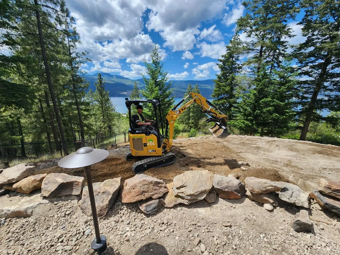 Jake Young one of the owners of Sweet Yards Landscaping LTD in a excavator