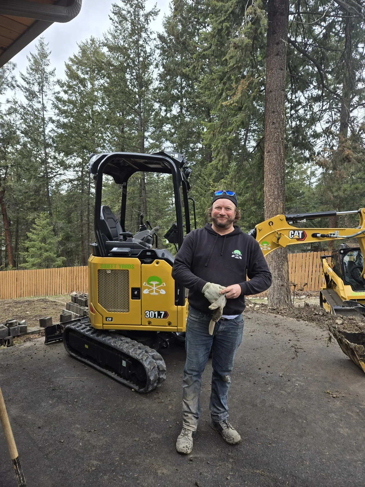 Rick Schoene one of the owners of Sweet Yards Landscaping LTD in a excavator