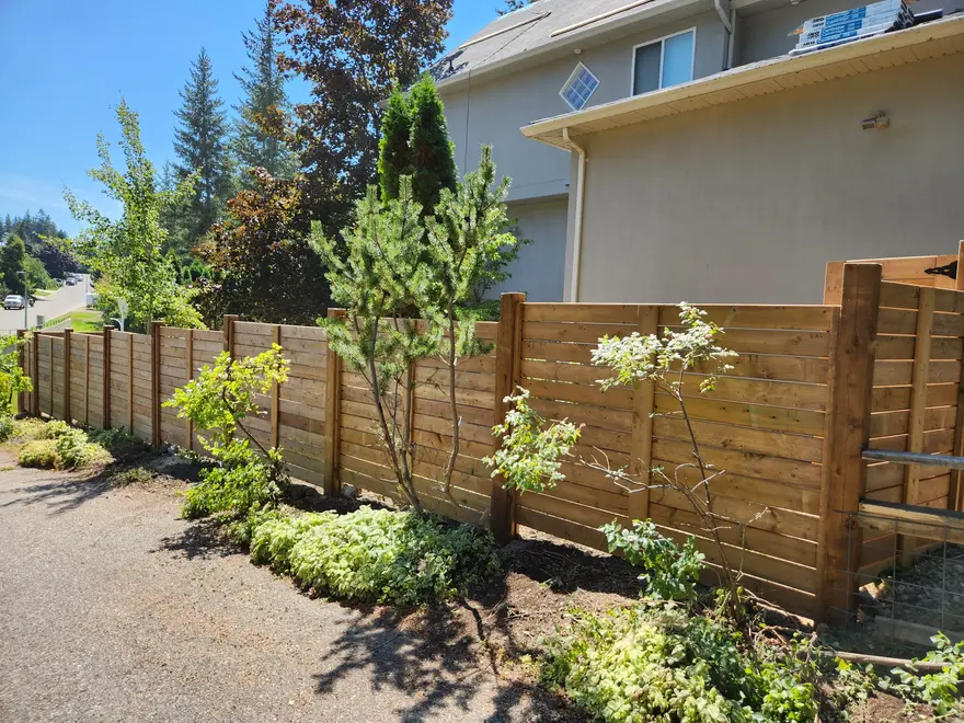 Asthetic wood fencing with shrubs and trees done by sweet yards in Kelowna