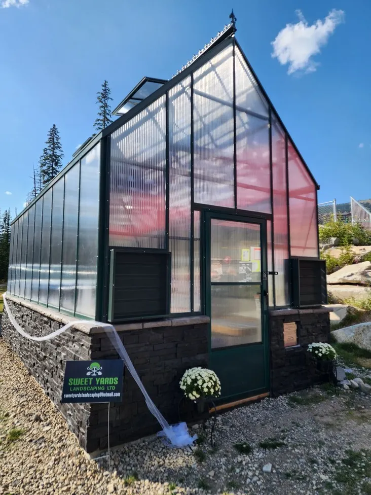 Greenhouse with black exterior and semi see through windows made by sweet yards in Kelowna