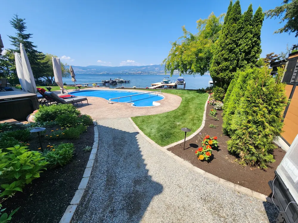 Lake front property with pool and beautiful yard done by sweet yards in Kelowna