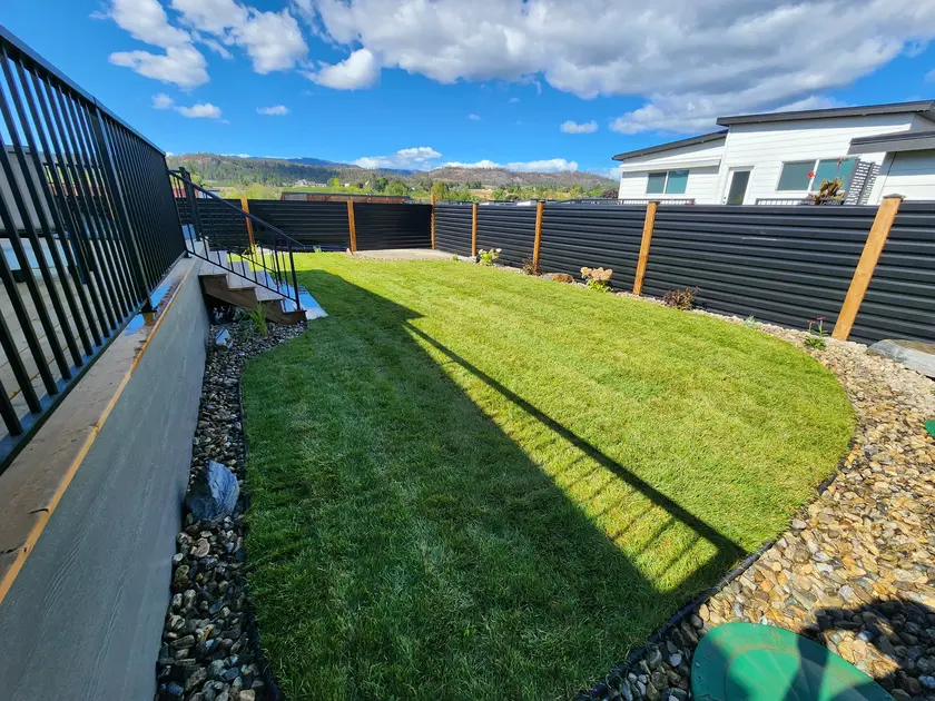 Green grass and beautiful black fence done by sweet yards in Kelowna